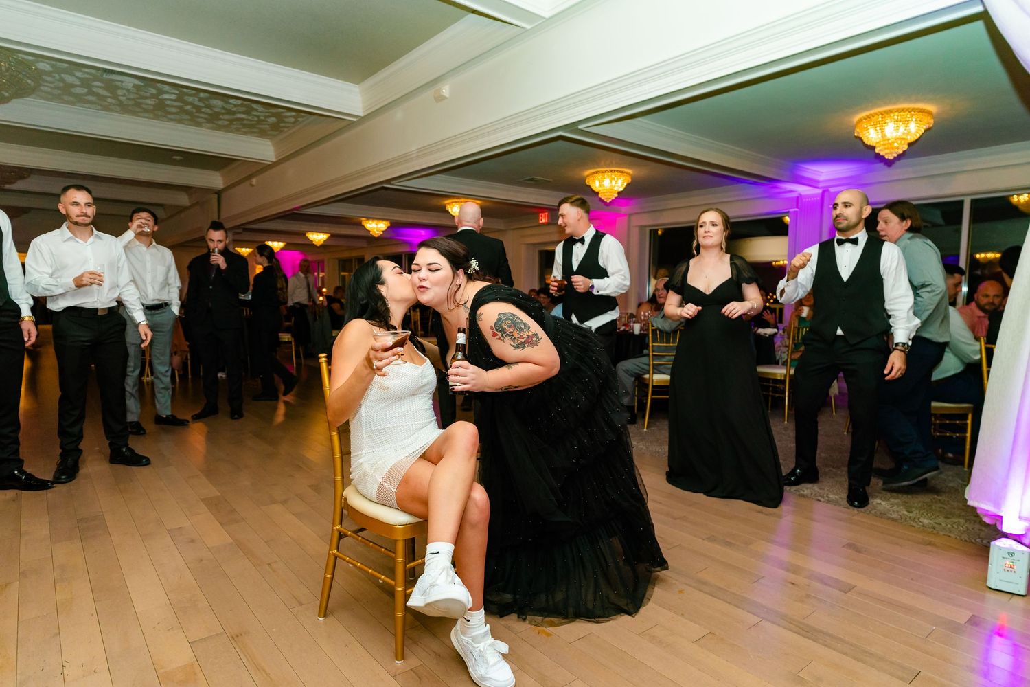Wedding reception panorama showing guests dancing across a spacious ballroom floor.