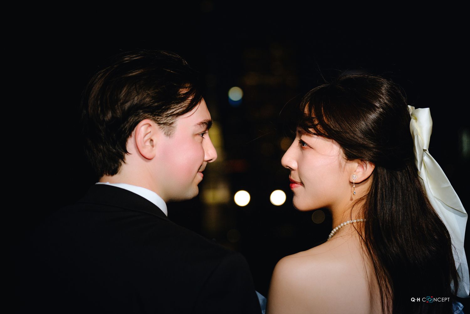 Intimate nighttime portrait with dramatic side lighting creating a moody atmosphere.