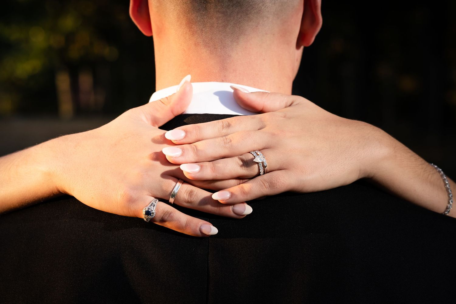 Close-up of hands touching in an intimate moment during a wedding ceremony.