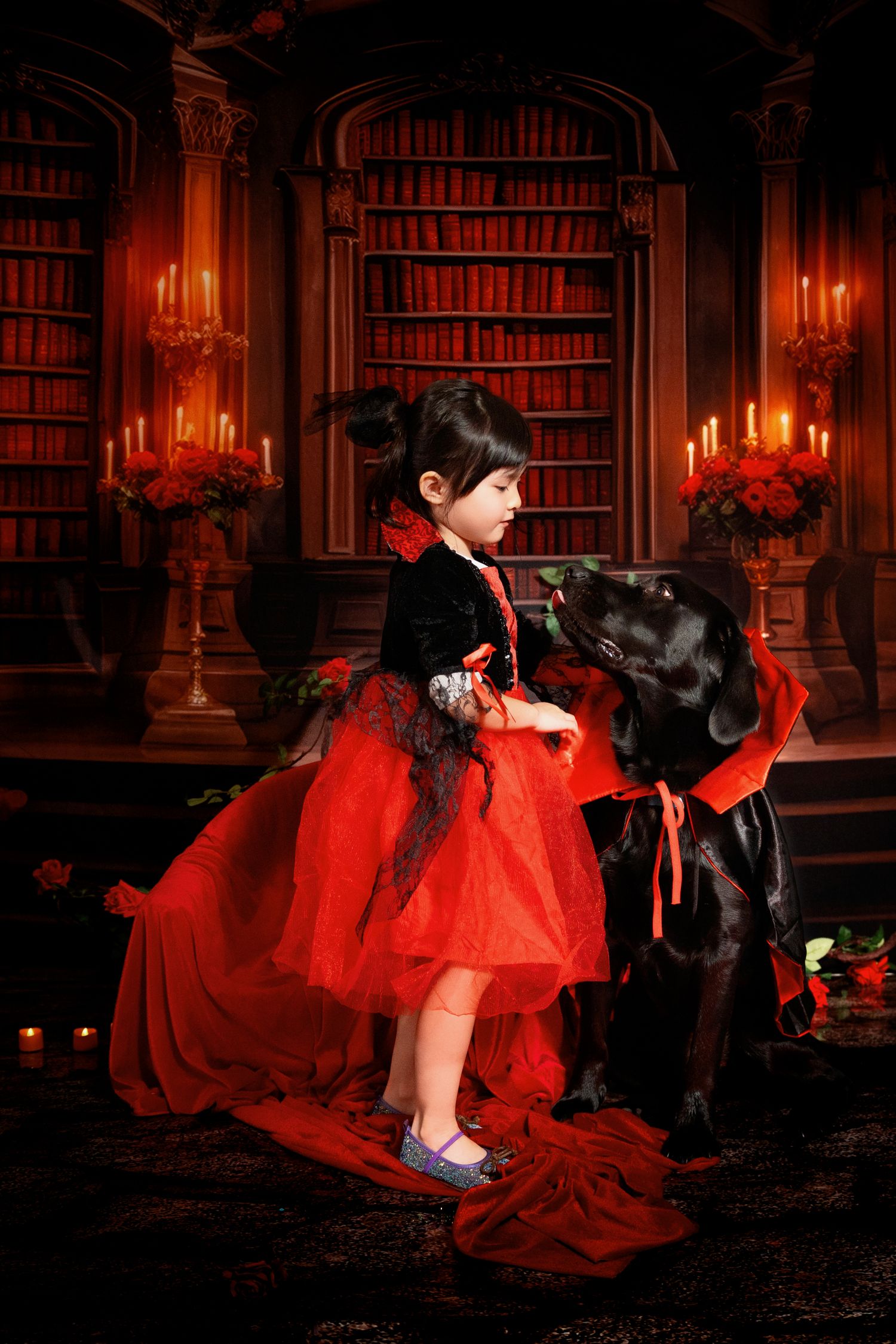 A dramatic scene in a candlelit library with red dress and black decor against bookshelves.