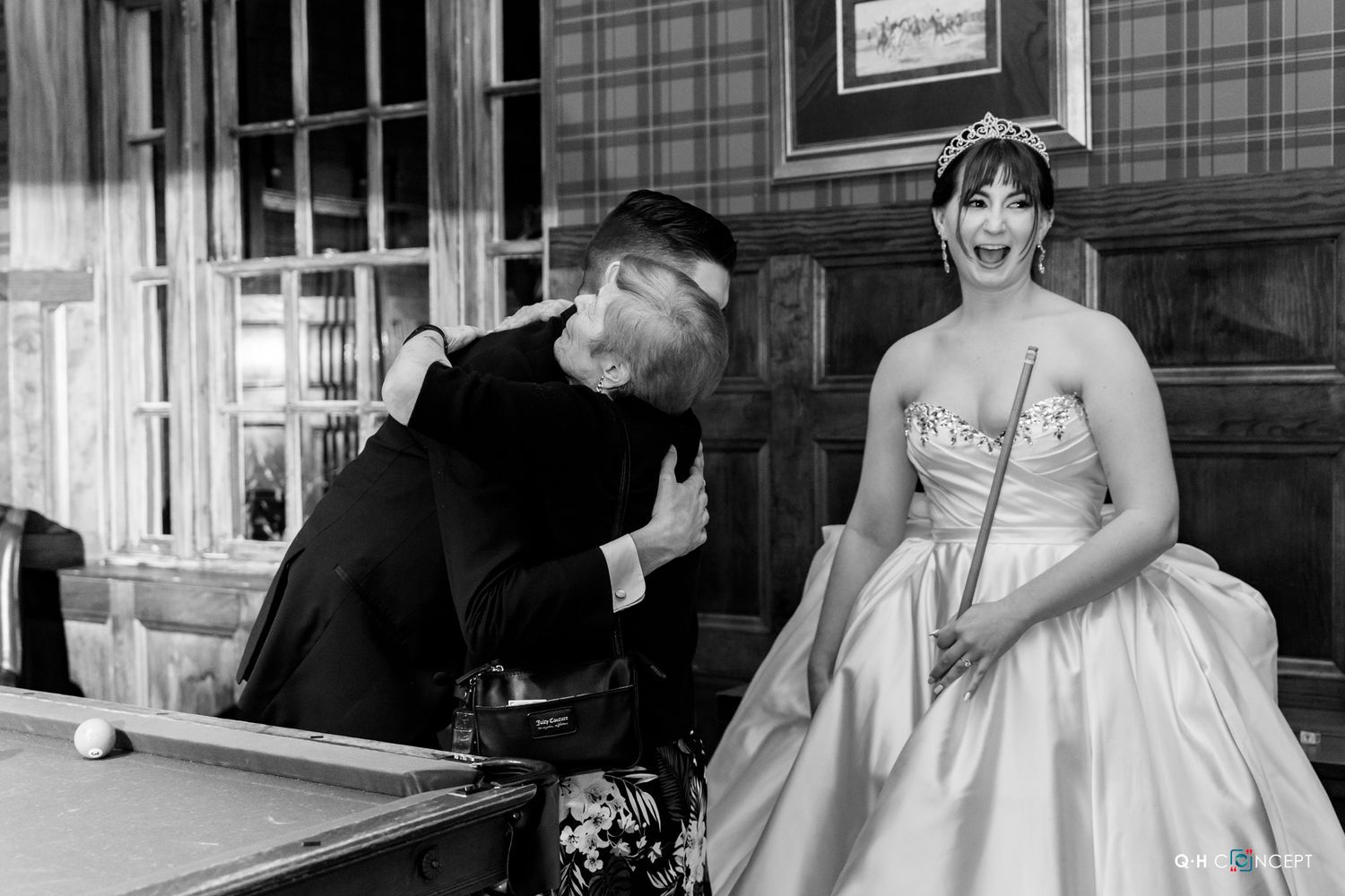 Black and white candid moment at a vintage-style wedding reception.