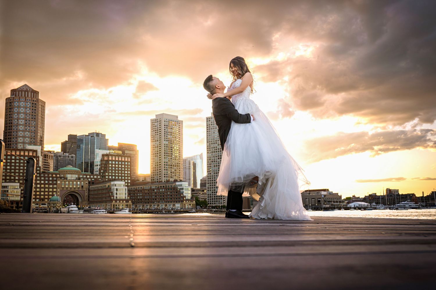 Dramatic sunset silhouettes against a cityscape backdrop with flowing white dress and architectural elements.