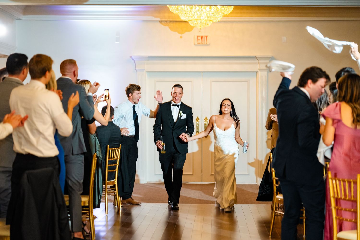 Wedding celebration in progress with guests dancing and mingling in an elegant reception hall.