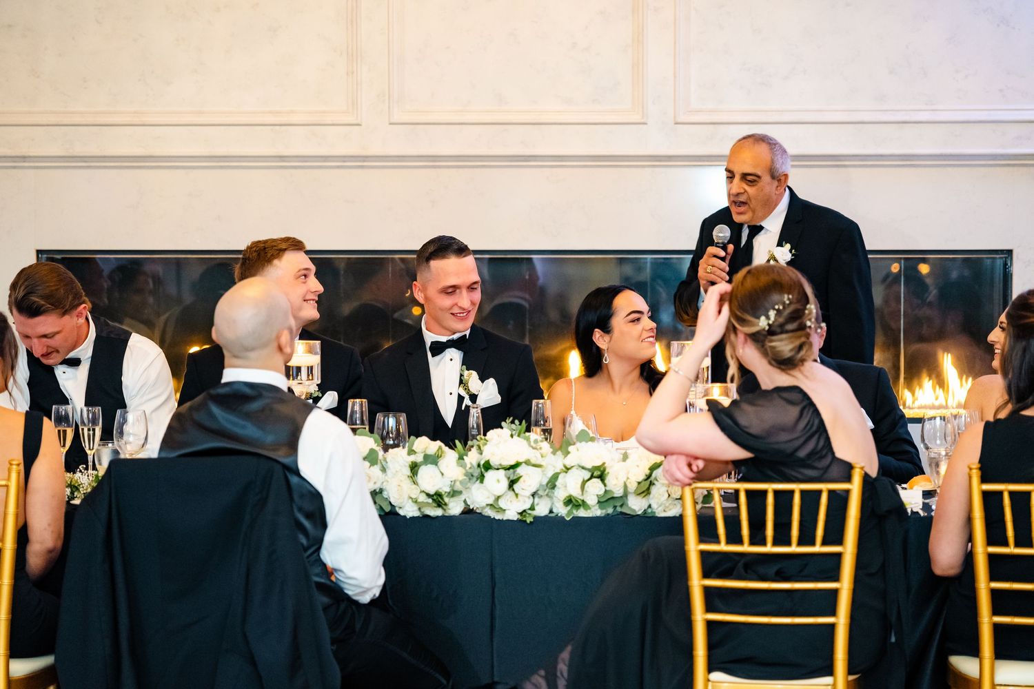 Wedding reception dinner setup with elegant table settings and floral arrangements.
