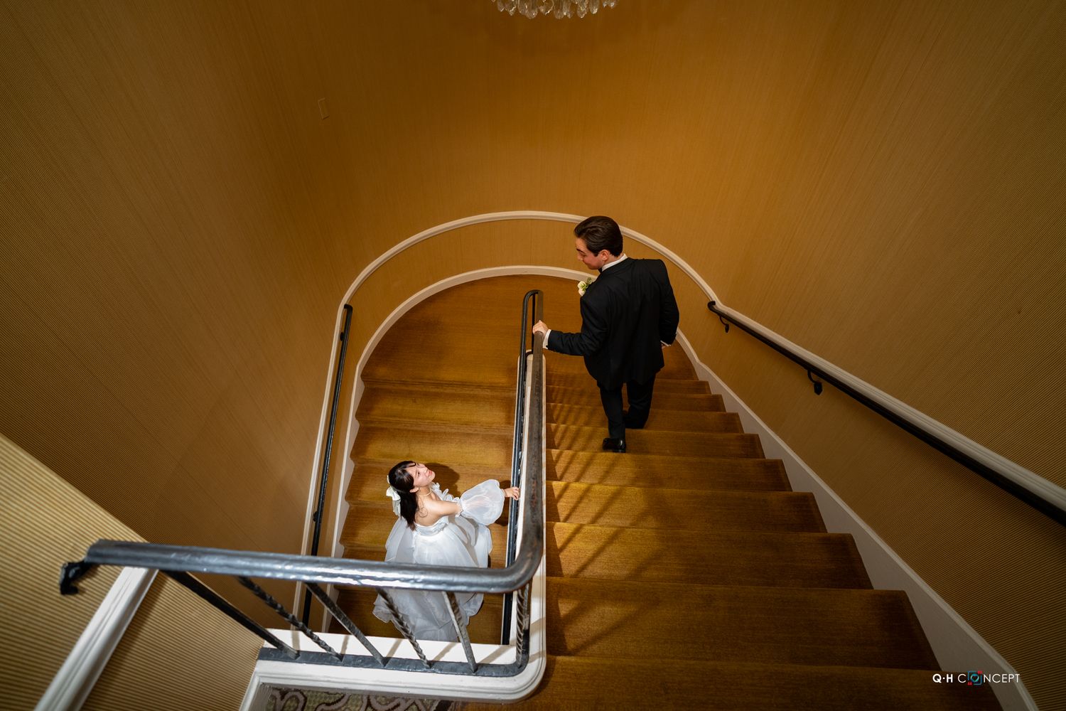 Wedding sequence captured on a grand staircase with warm ambient lighting.