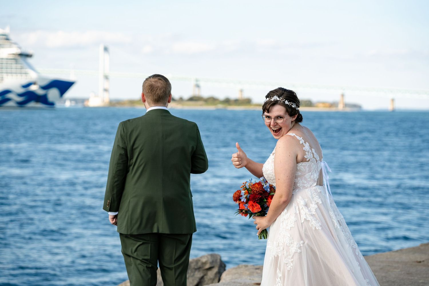 Couple shares romantic moments along waterfront during sunset wedding photoshoot.