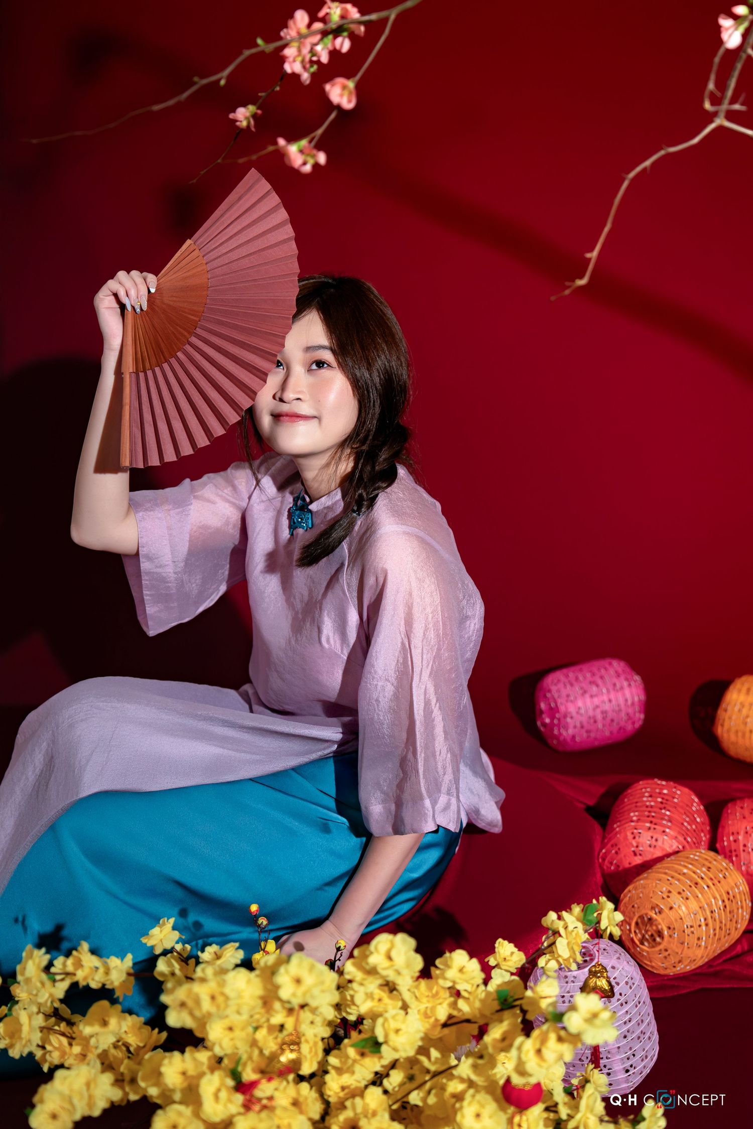 A series of artistic photos with a pink and teal color scheme featuring yellow flowers and decorative fans against a red backdrop.