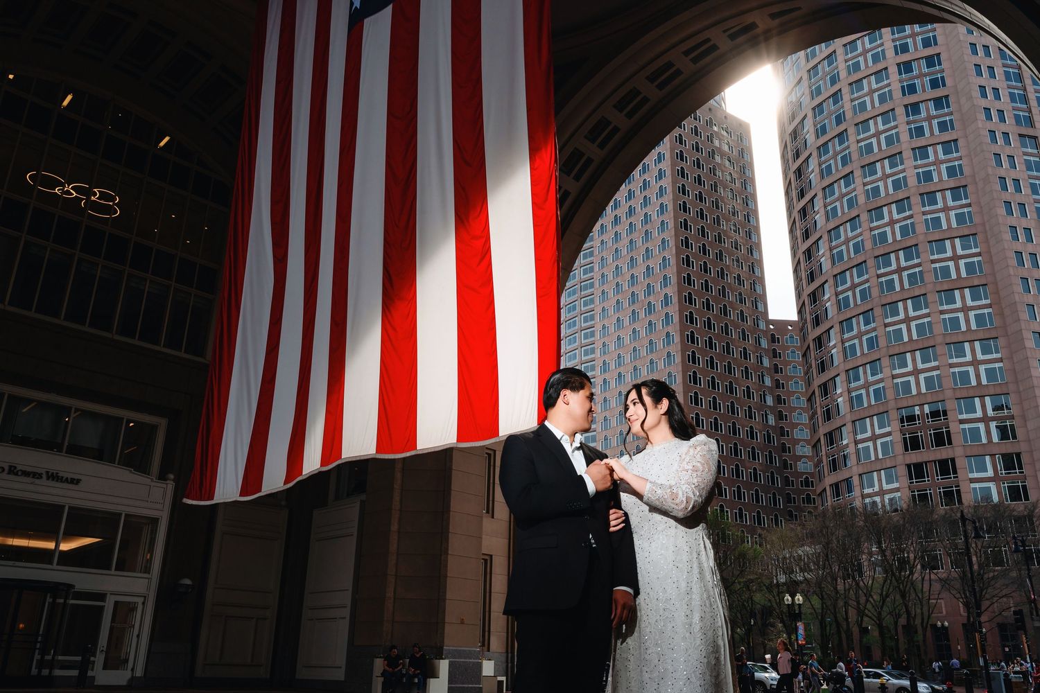 Dramatic architectural shots featuring large American flags hanging in an urban setting.