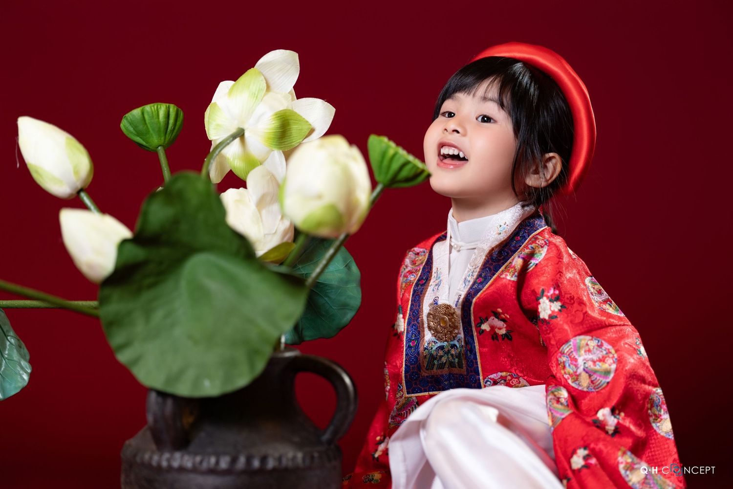 Traditional Japanese-style portrait with white lotus blossoms and red fabric against dark background.