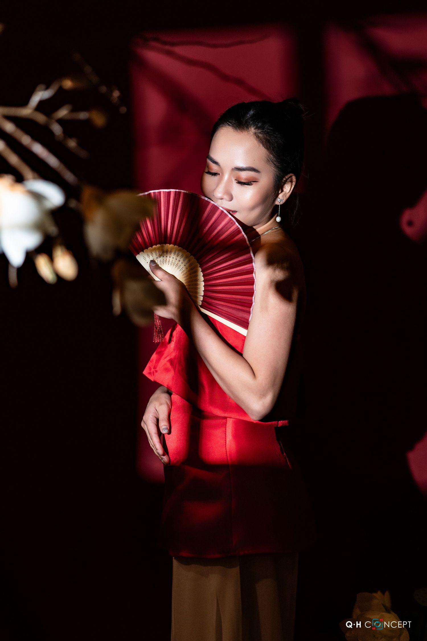 Artistic photo series with red paper fan and dramatic lighting creating moody Asian-inspired portraits.