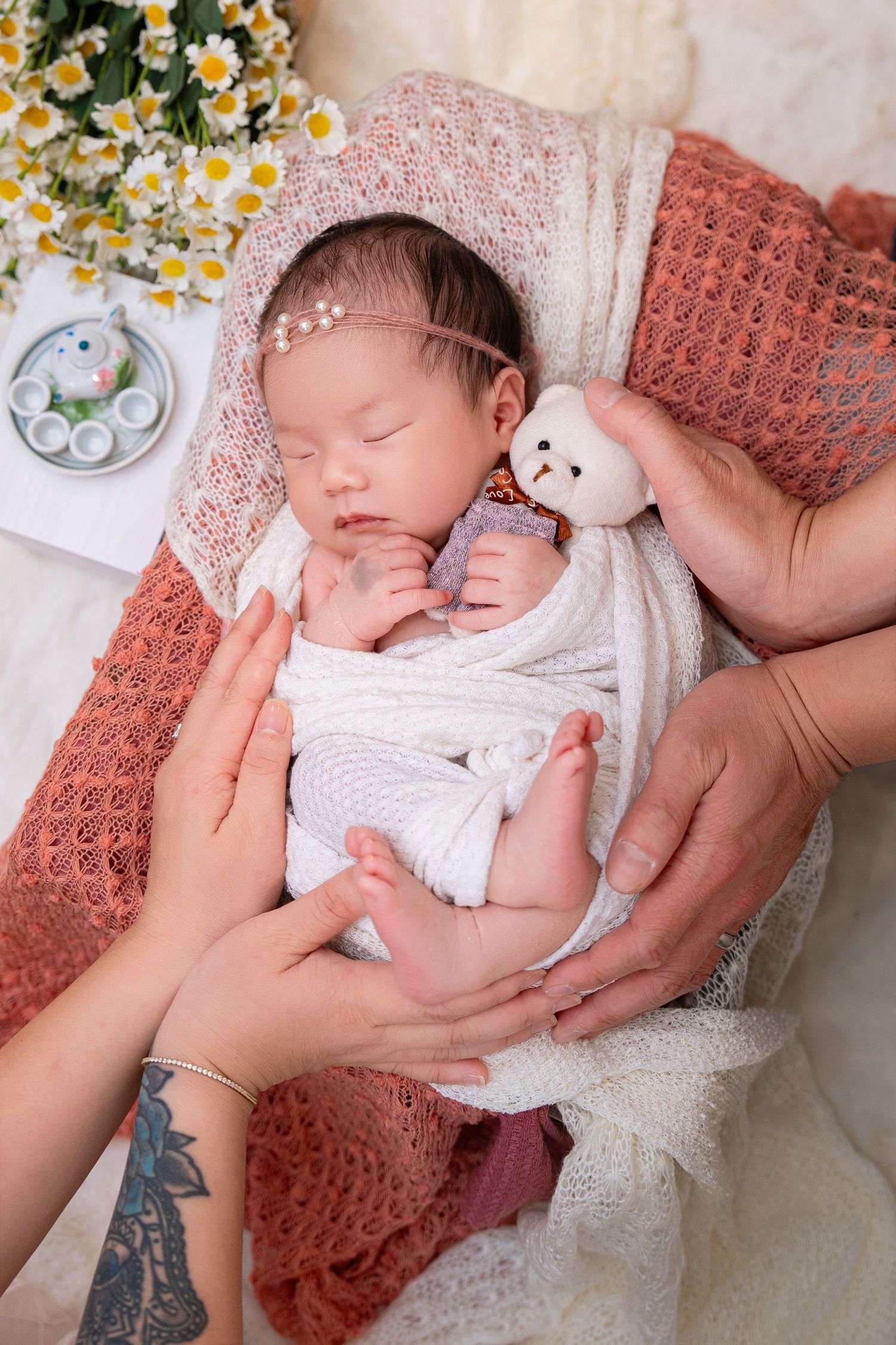 Newborn photo with cute session, interacting with parents with their hands holding babies