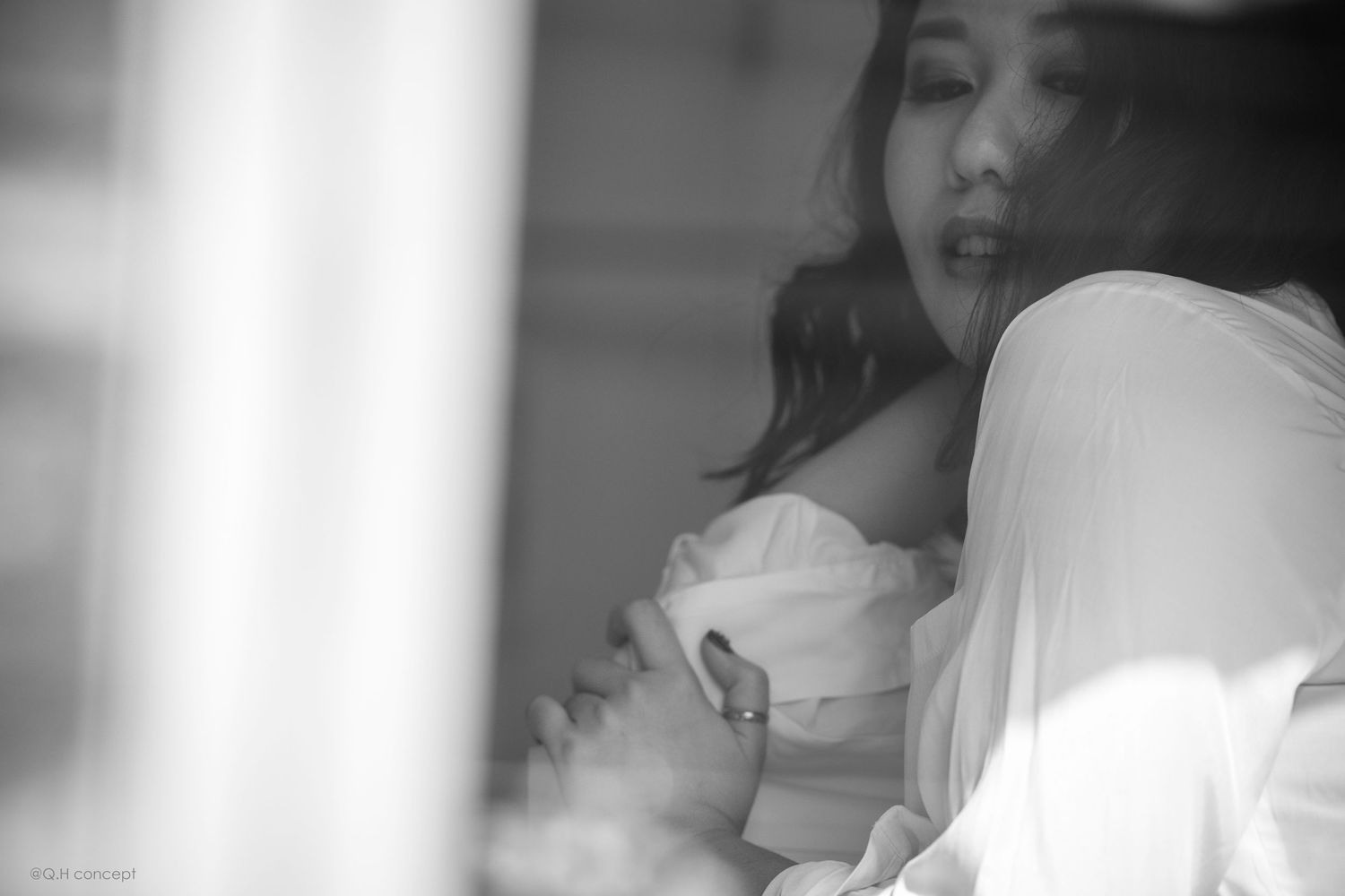 Soft focus black and white boudoir photography with dreamy window light.