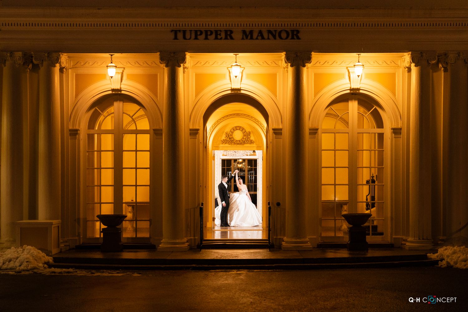 Elegant illuminated manor exterior with classic architecture at night.