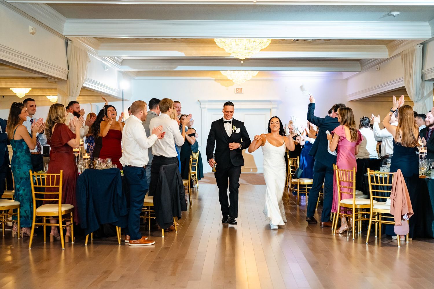 Reception guests line the dance floor during a celebratory wedding moment.
