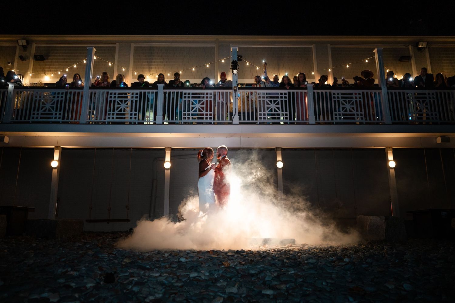 Wedding venue at night with dramatic lighting and fog effects.