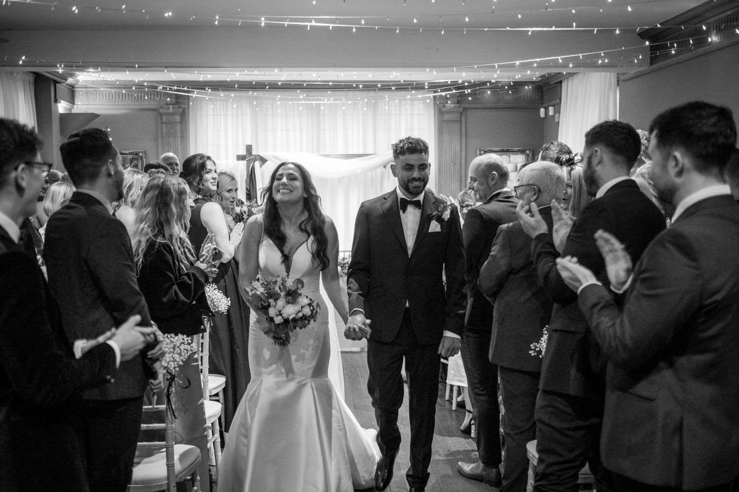 Newlyweds walking back down the aisle smiling