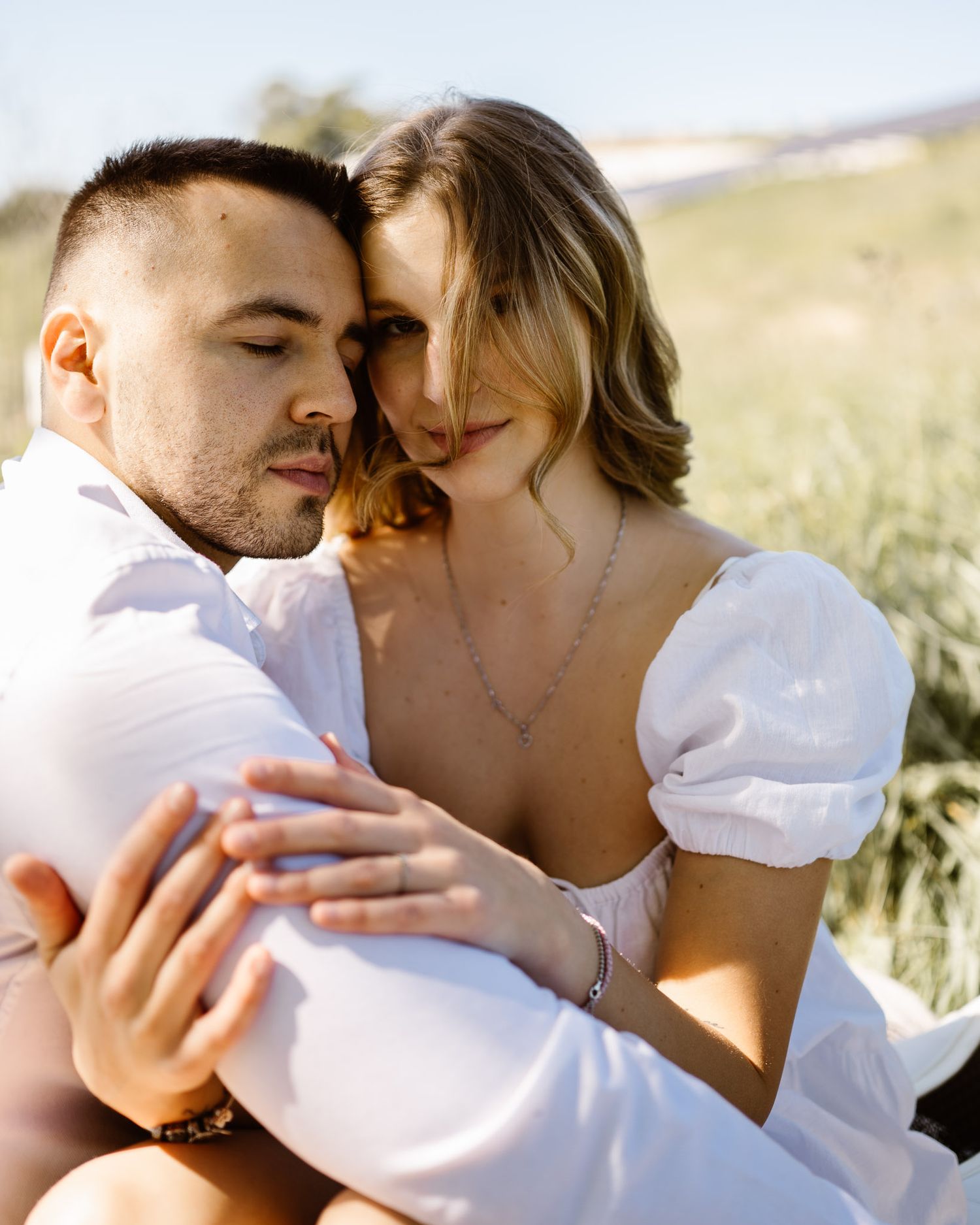 Intimate close-up sequence of a couple sharing tender moments in sunlight.