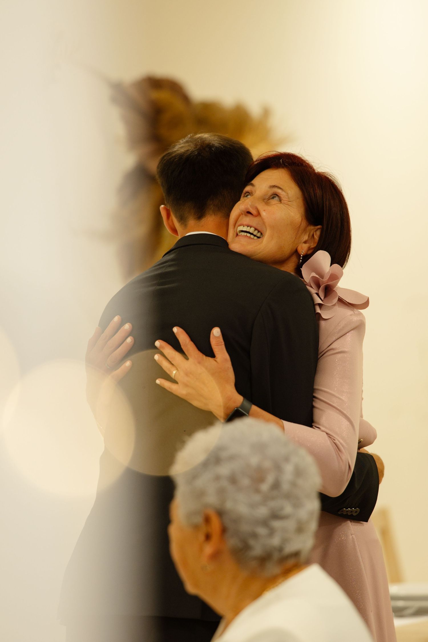 An emotional embrace shared during a wedding celebration.