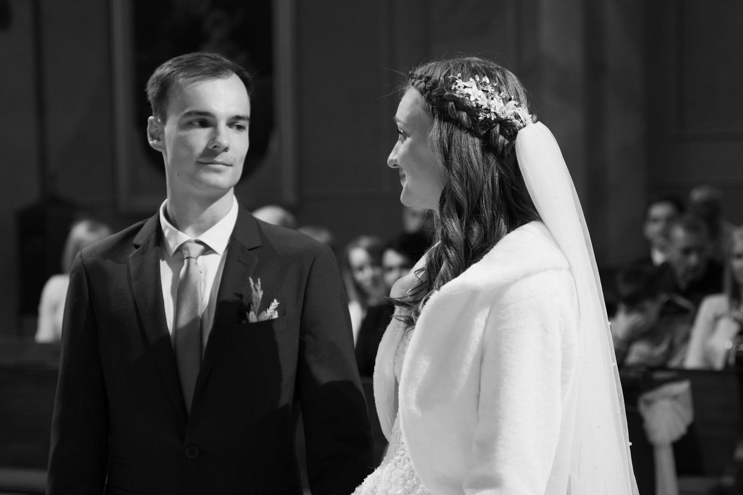 Black and white photo of a wedding ceremony in a traditional church setting.
