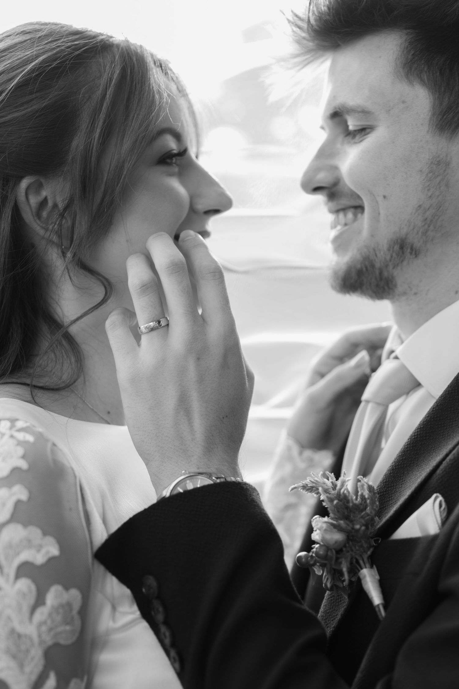 A black and white portrait of a tender moment between newlyweds showing genuine emotion.