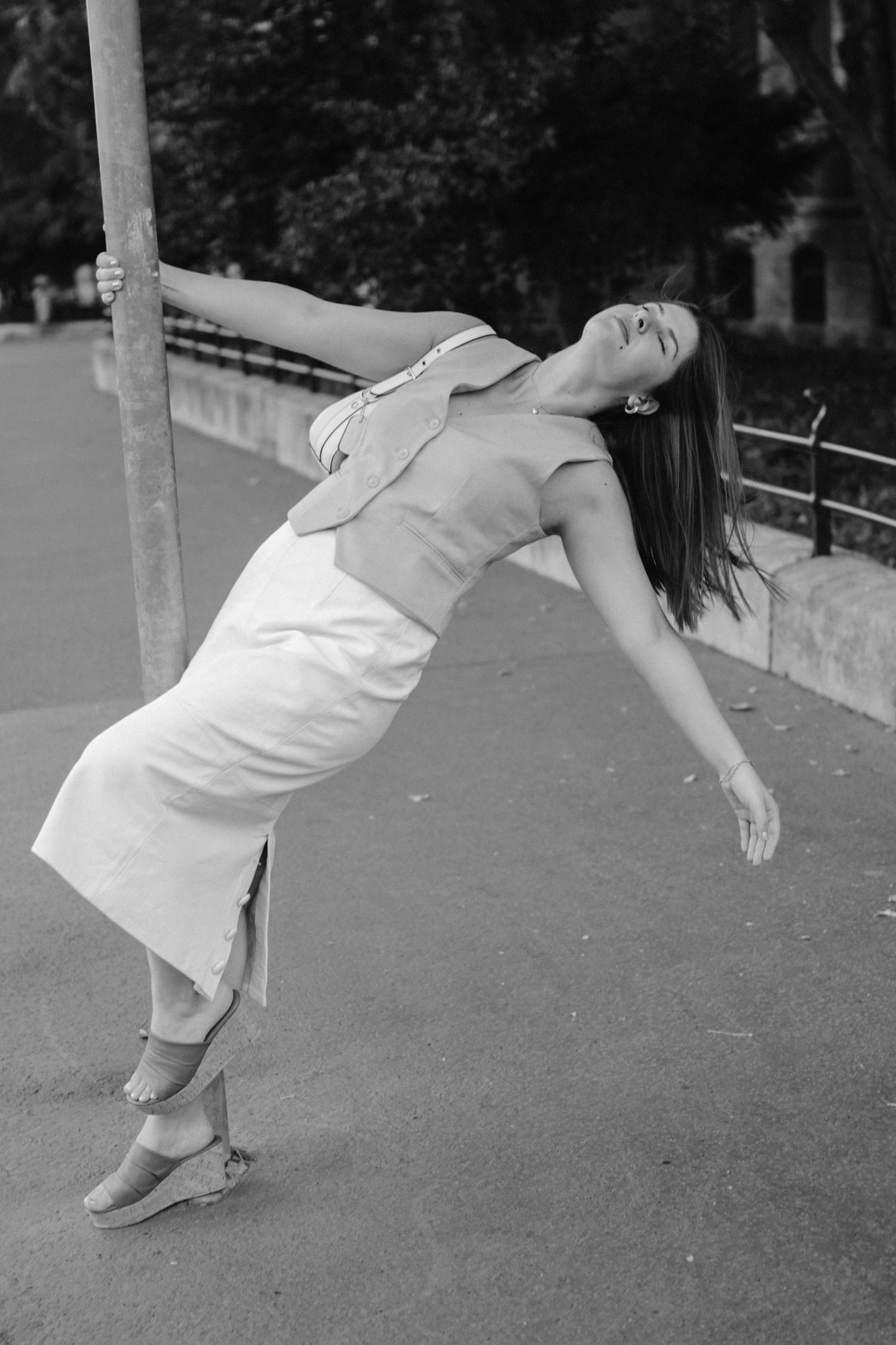A sequence of black and white photos showing a person in white clothing leaning backwards in a falling motion.