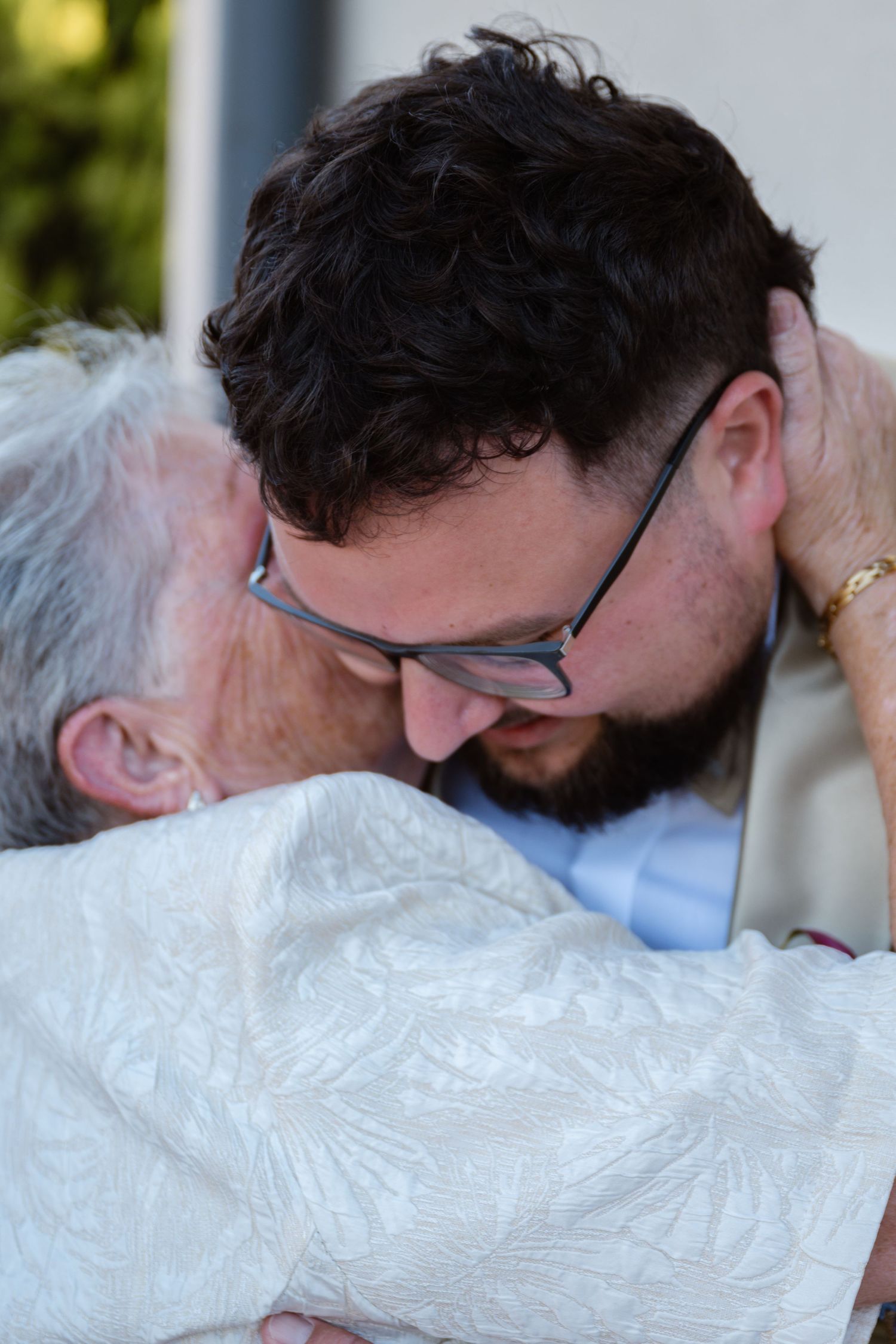 Tender embrace captured in sequence during wedding celebration.