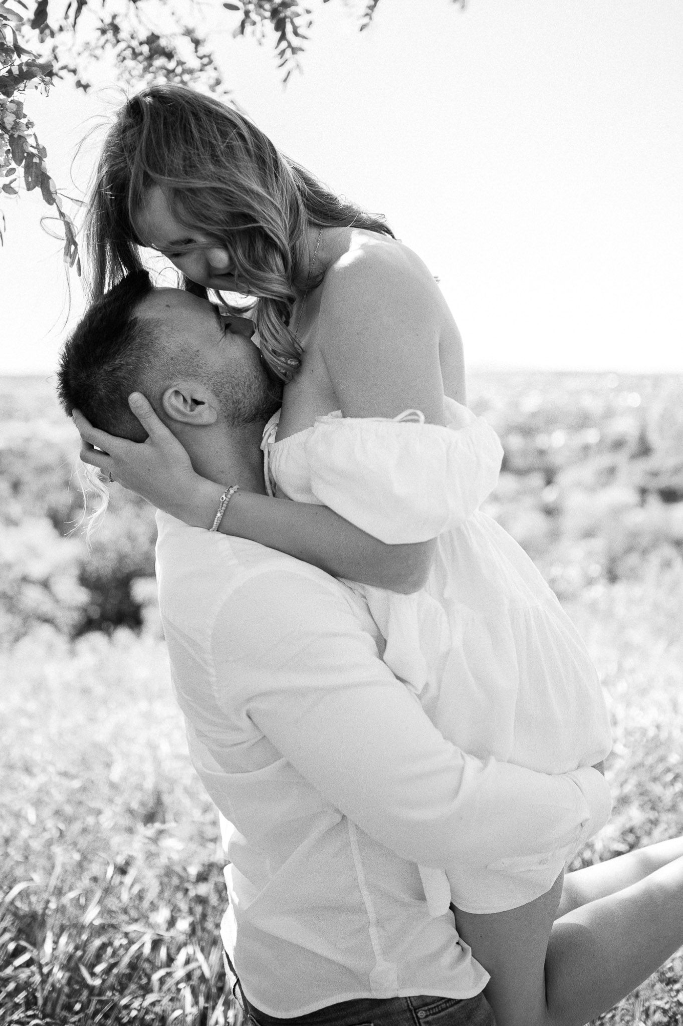 Intimate black and white portrait session in a natural outdoor setting.
