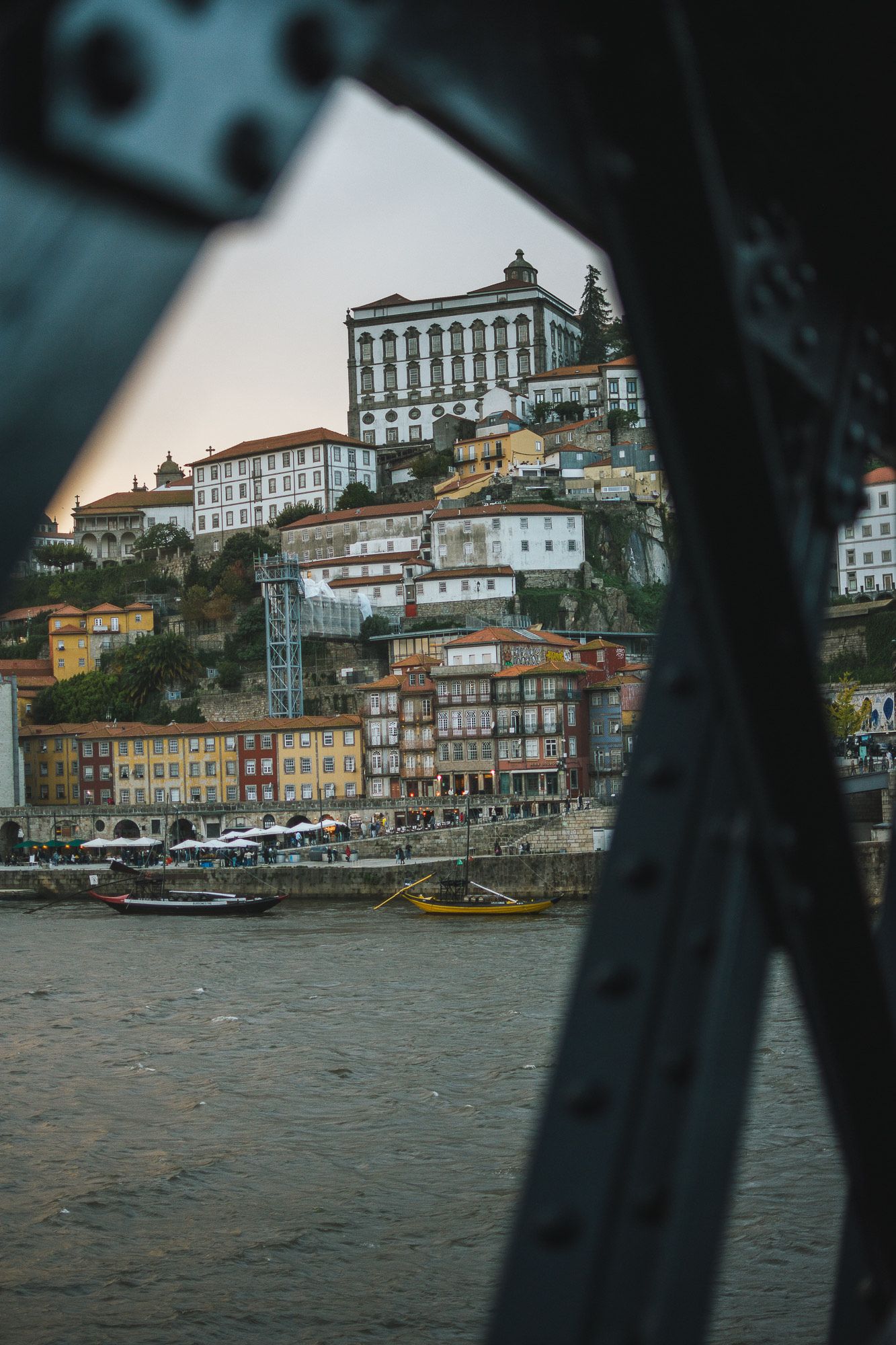 Historic Porto cityscape with traditional buildings cascading down hillside to the river.