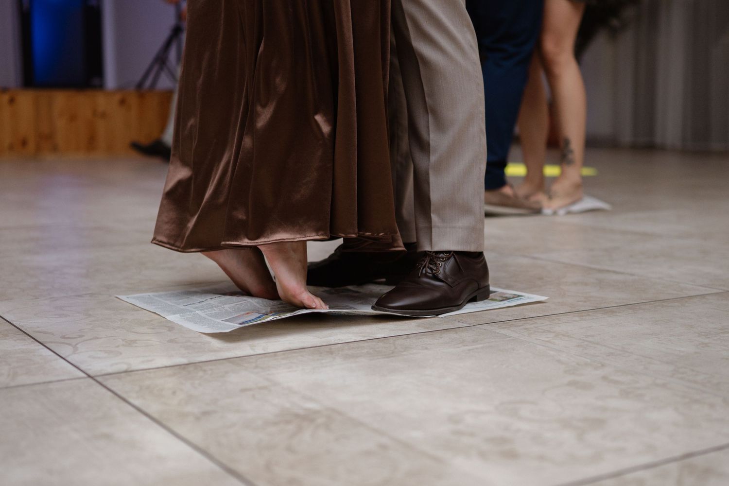 Dance floor detail showing formal attire and movement during a celebration.