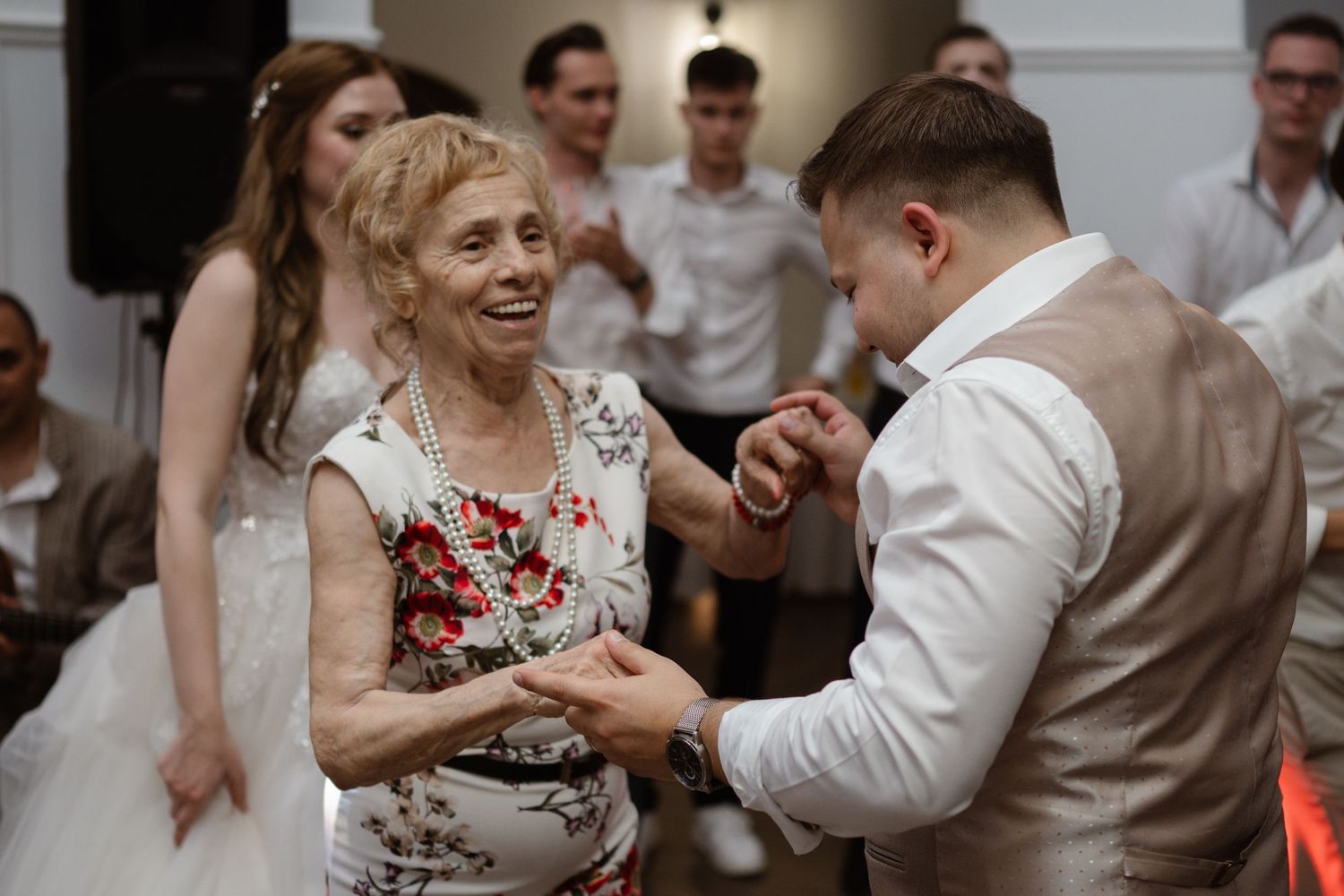 Wedding guests sharing joyful moments on the dance floor.