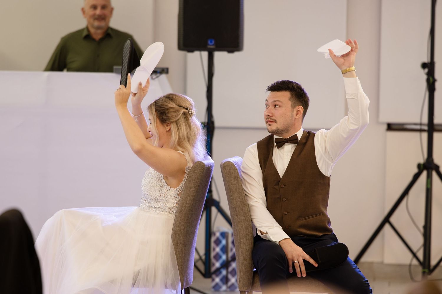 Wedding reception dance party with guests raising glasses and dancing.