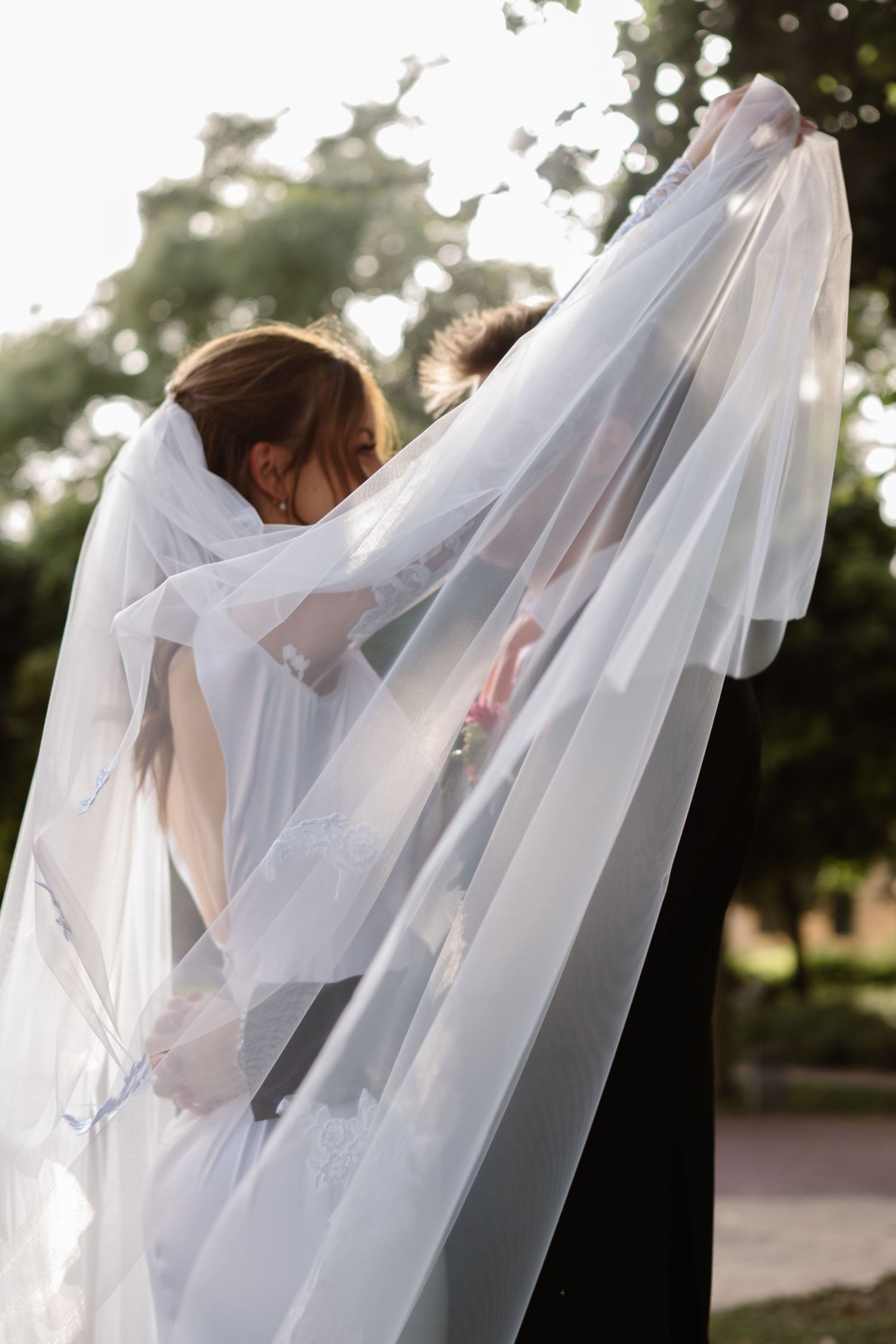Artistic wedding photography sequence showing flowing white veil movement in natural light.