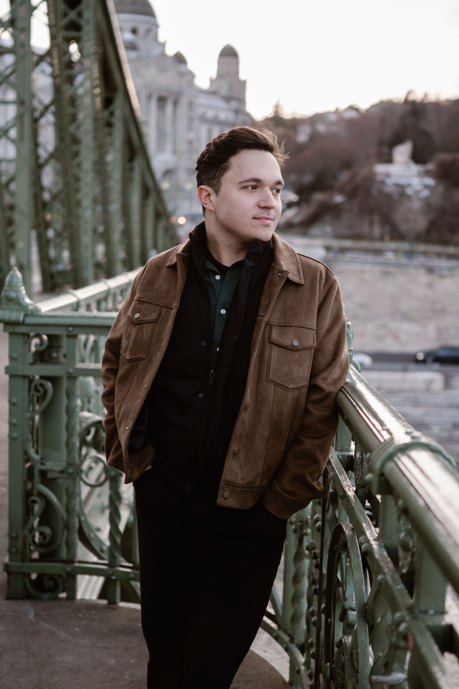 Portrait series on an iron bridge showing casual poses against urban backdrop.