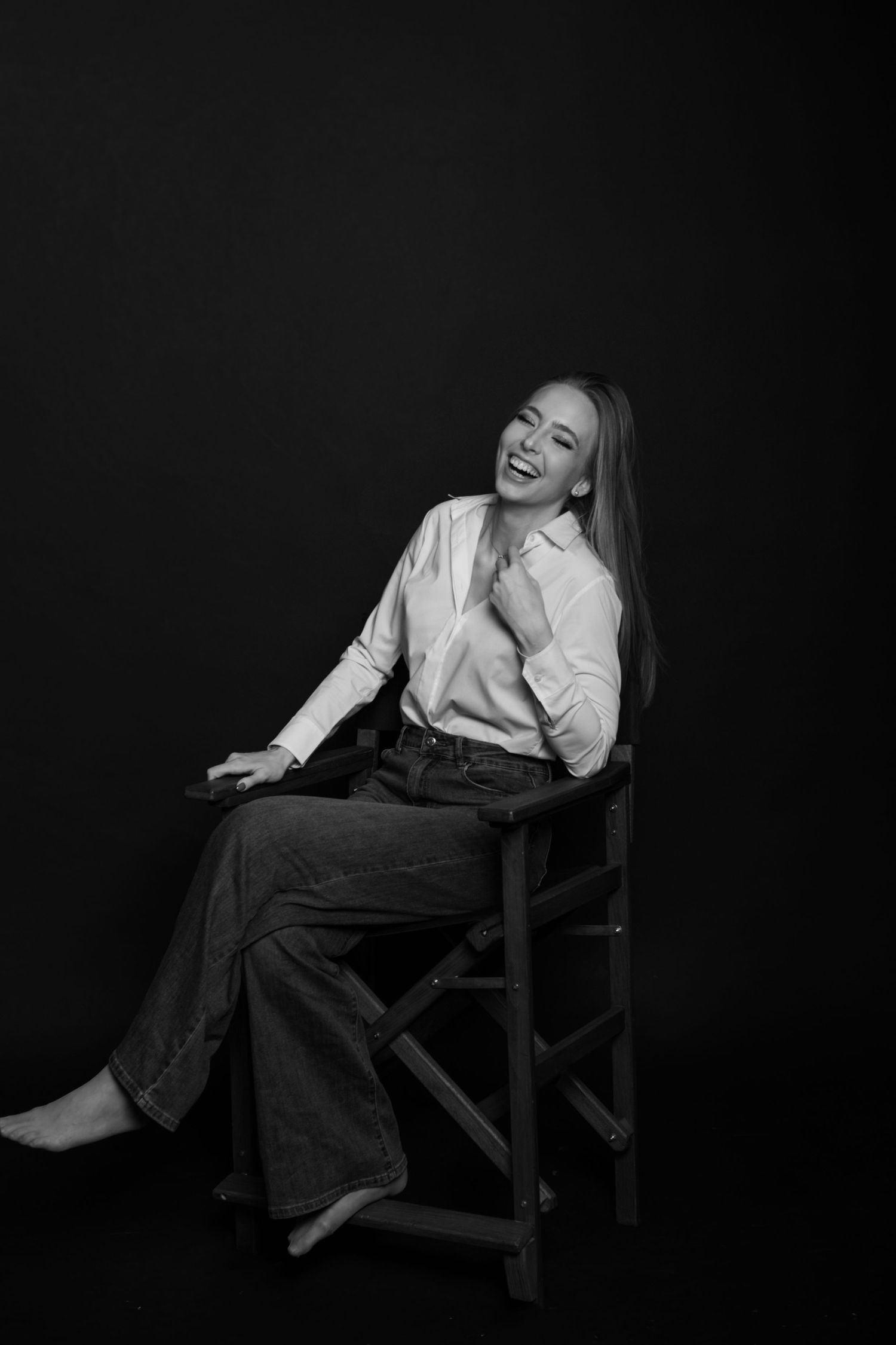 Dramatic black and white portraits showing candid laughter and relaxed poses in a chair.