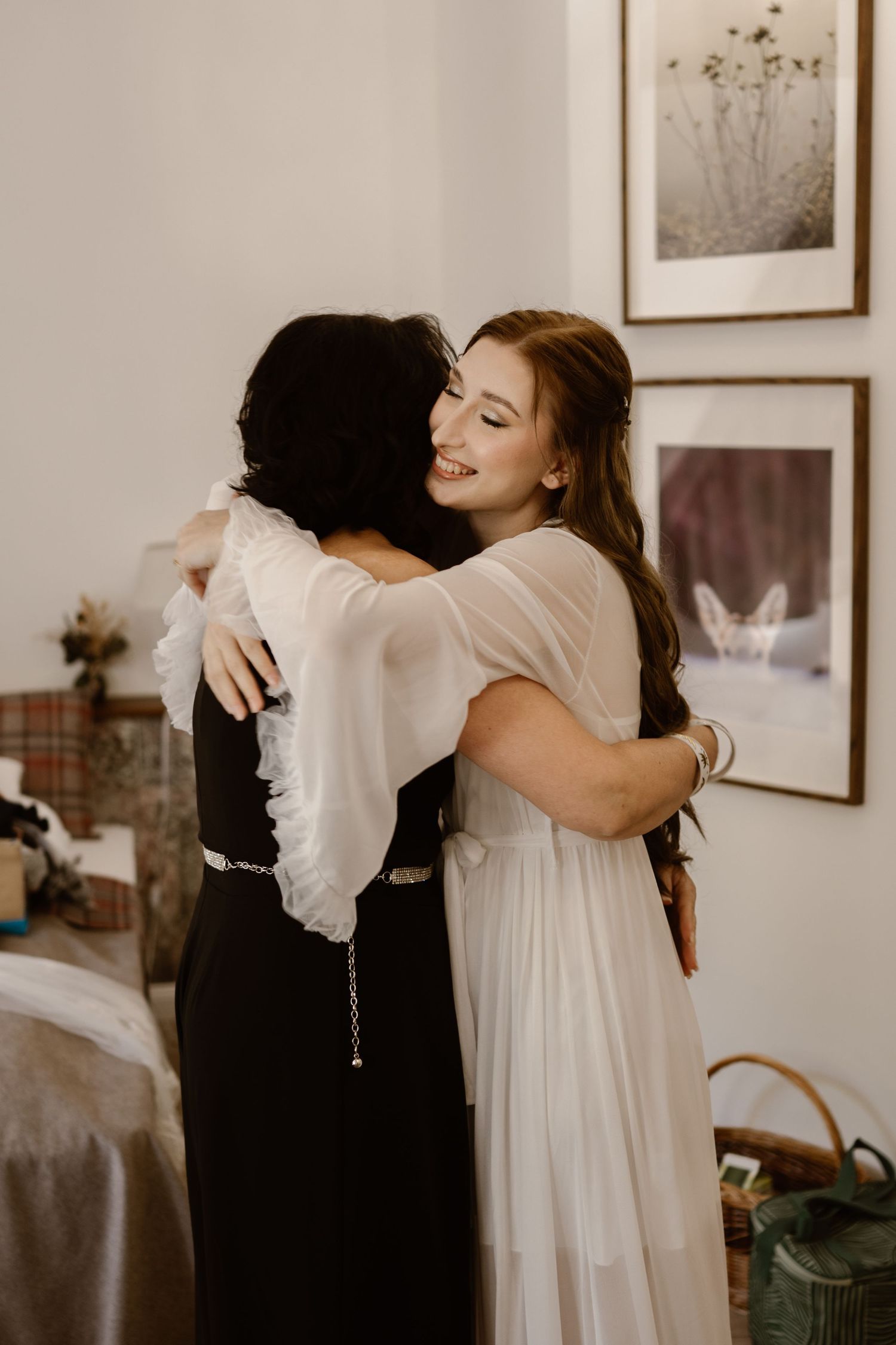 Emotional wedding moment captured in black and white with people embracing.