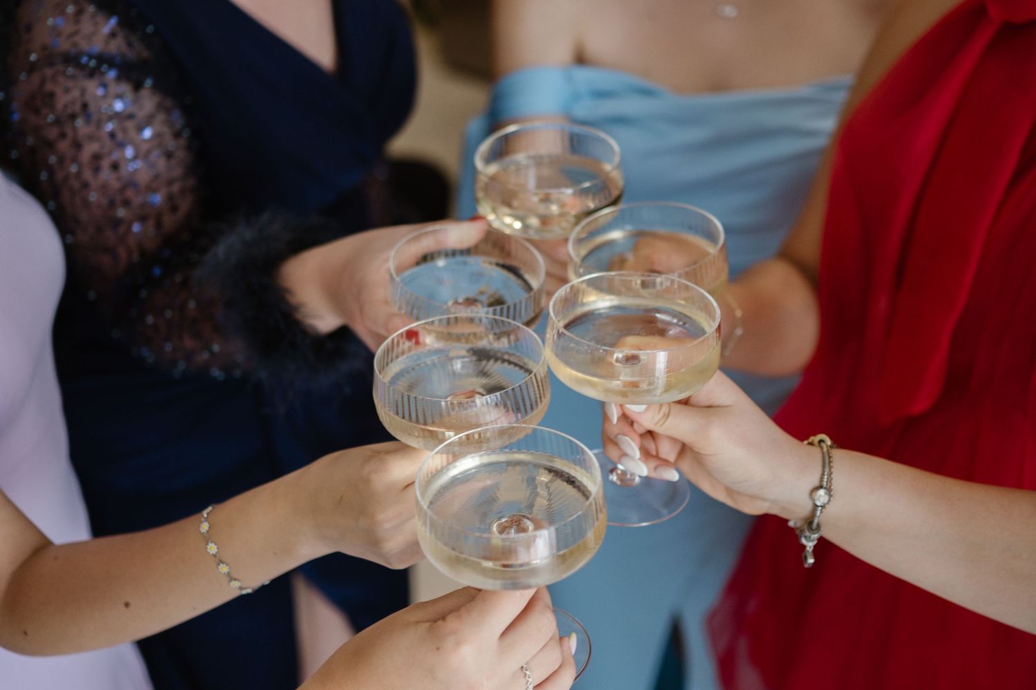 Wedding guests raising champagne glasses in a celebratory toast.