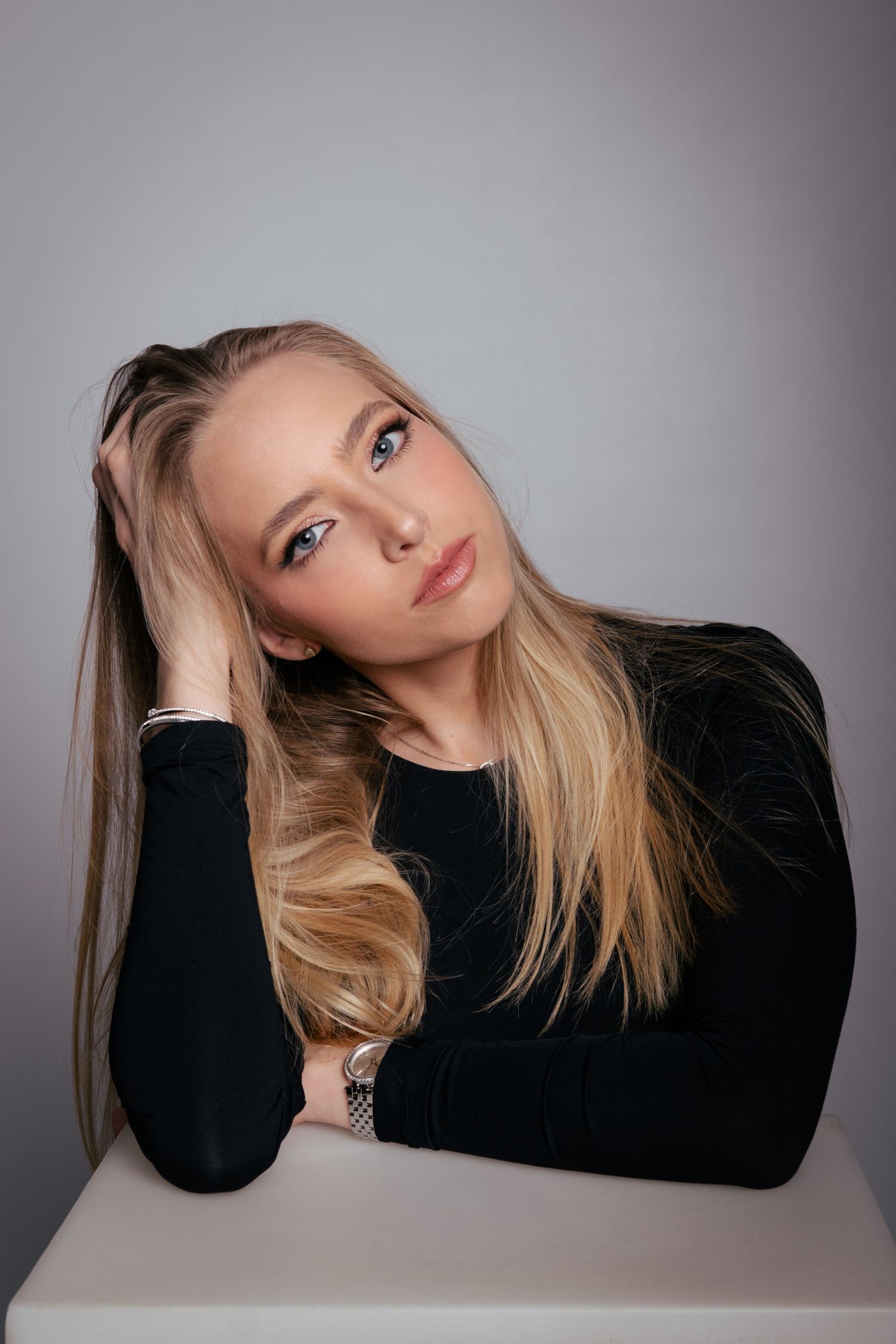Studio portraits against grey background showing artistic poses and expressions.