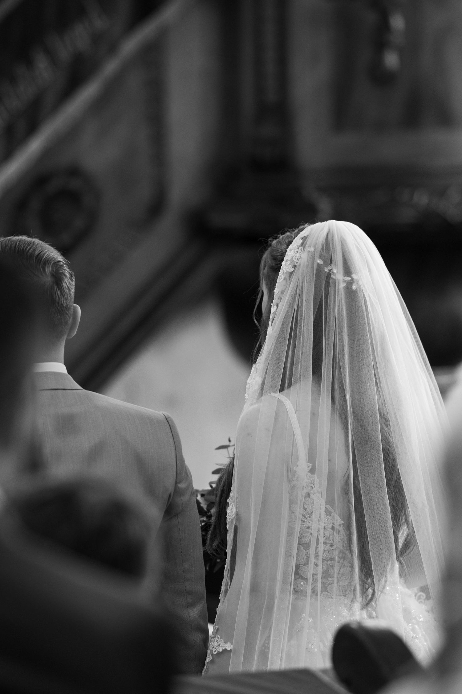 Black and white image of a wedding veil flowing in gentle movement.