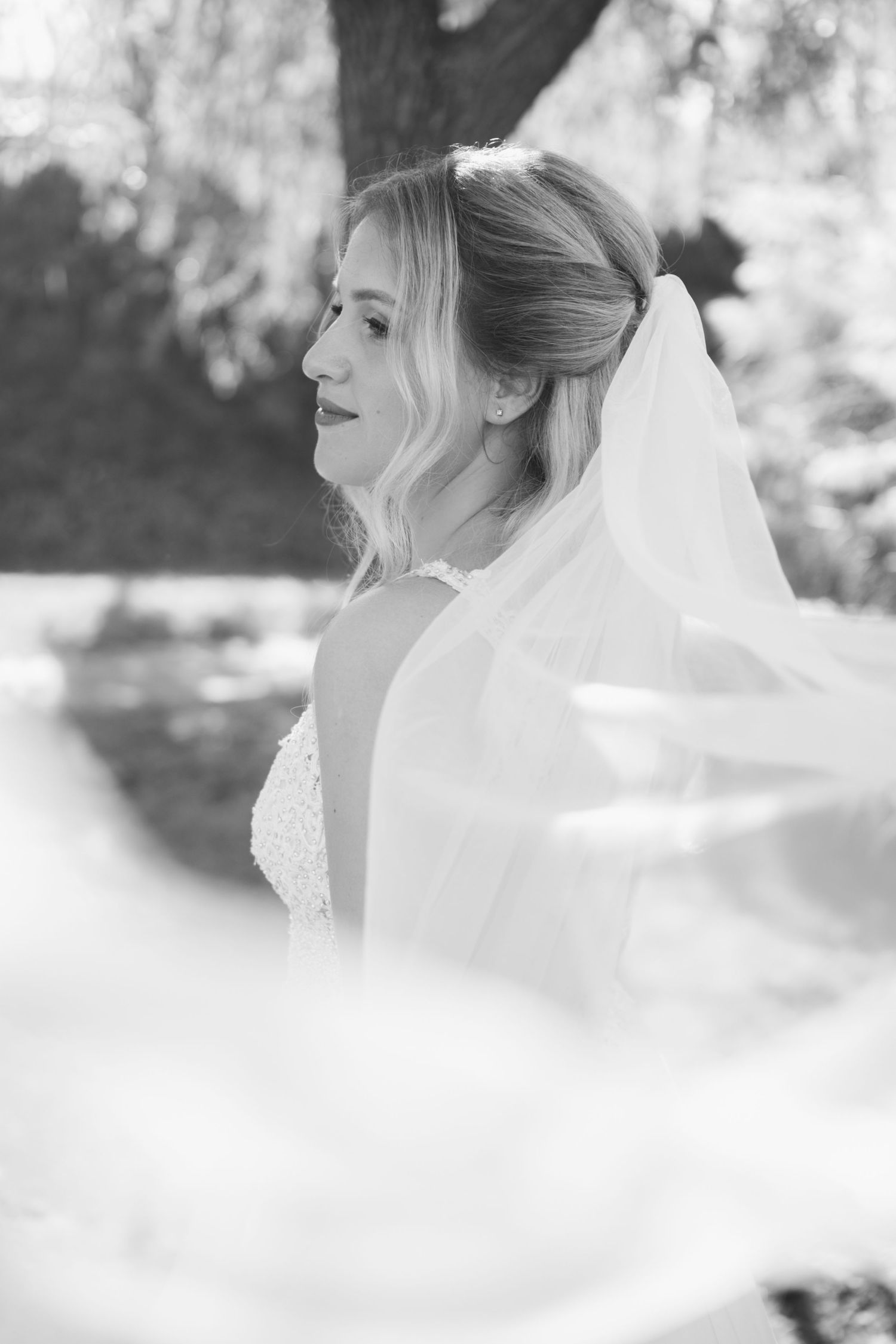 Ethereal black and white bridal portrait with soft dreamy focus.