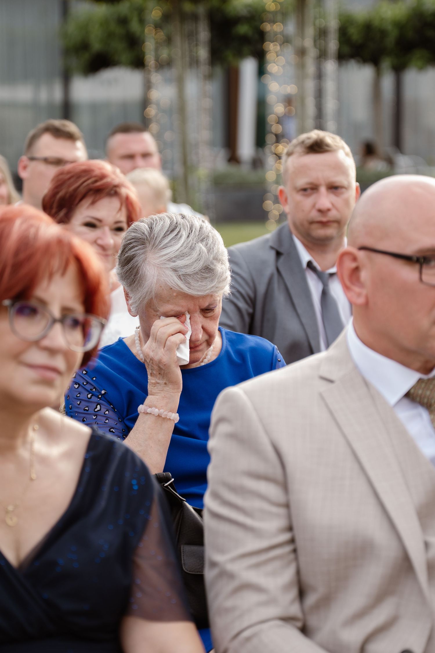 Wedding guests showing emotional reactions during ceremony.