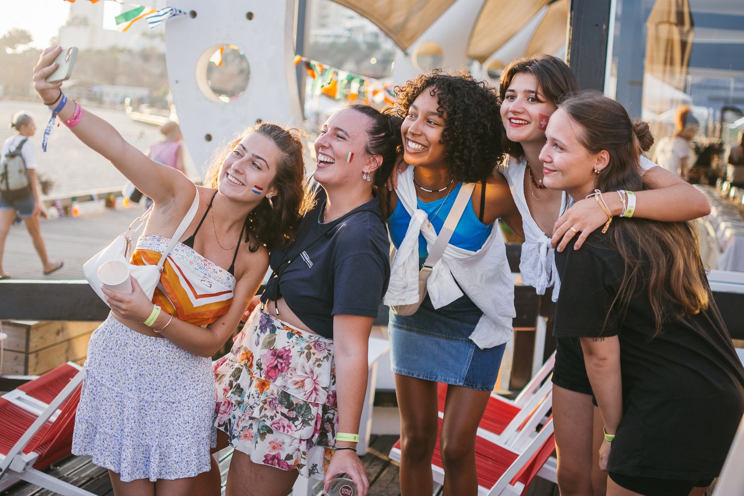 Happy crowd celebrating at an outdoor summer party.