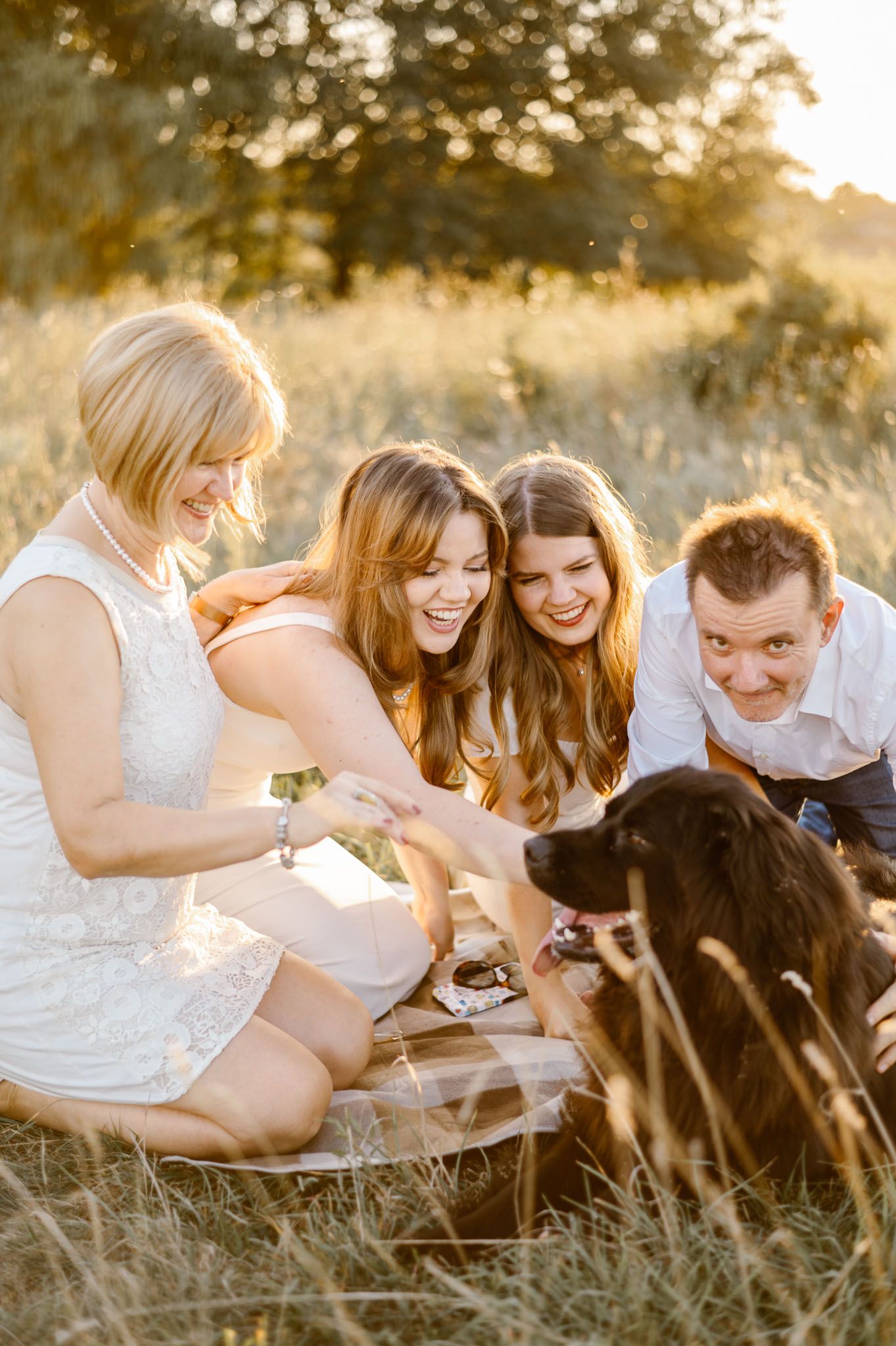 Group lounging together in a sun-drenched field during golden hour.