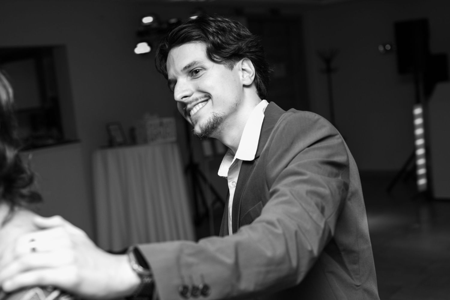 Black and white photos capture joyful dancing moments at a wedding reception.
