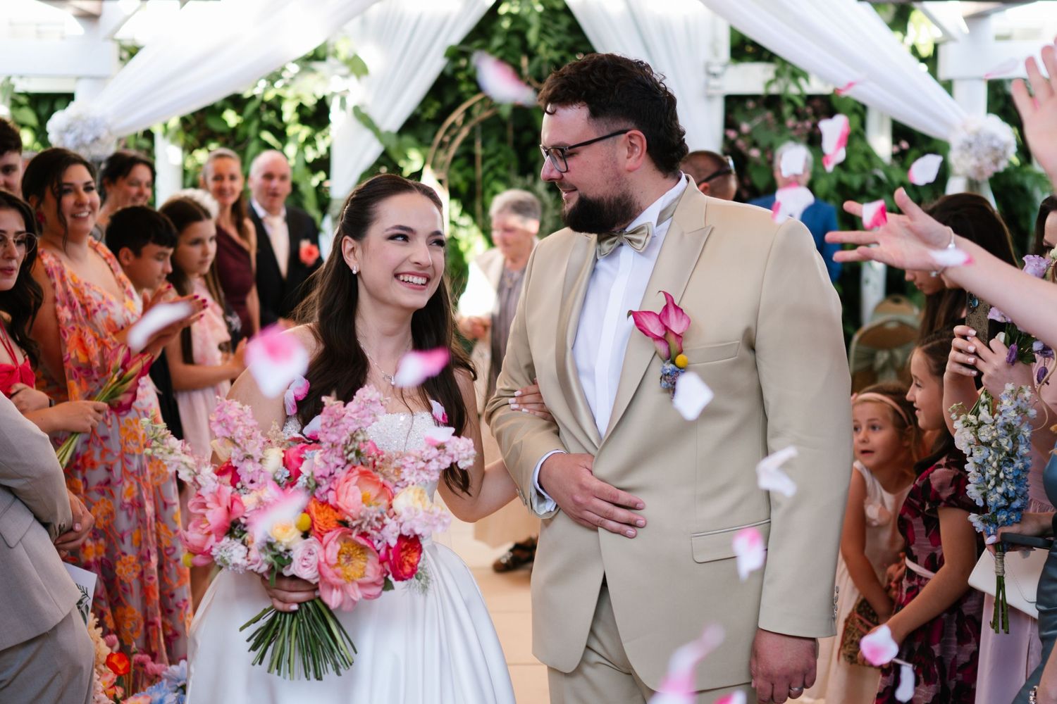 A wedding celebration montage showing joyful moments with guests and dancing in an outdoor setting.