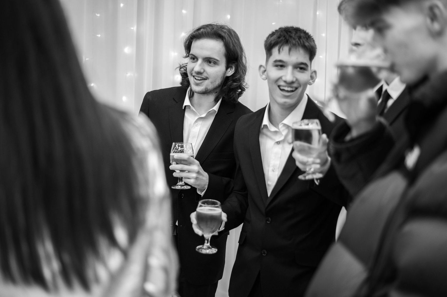 Guests mingling and enjoying drinks at an elegant indoor reception.