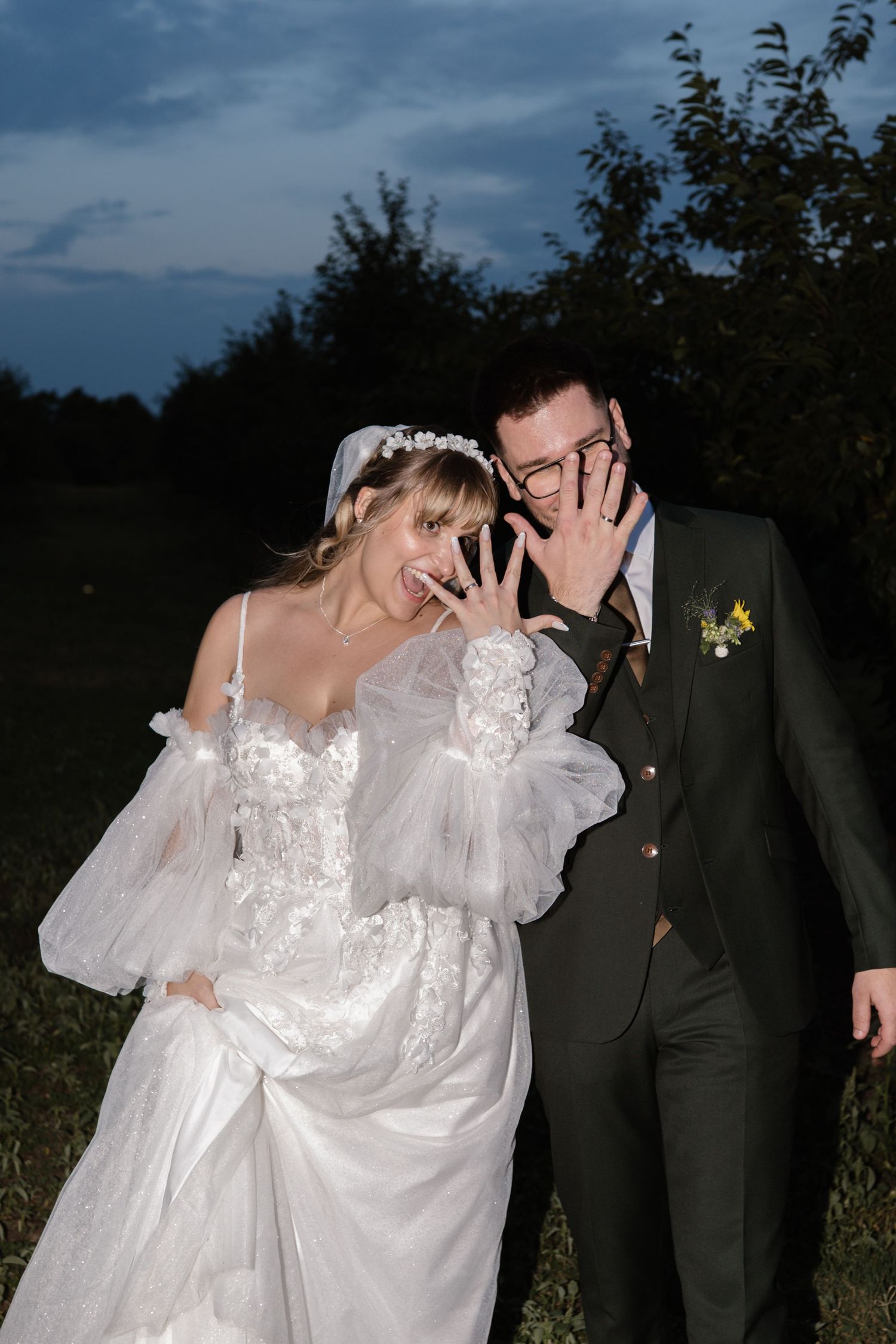 Intimate wedding portraits taken at twilight among trees and natural scenery.