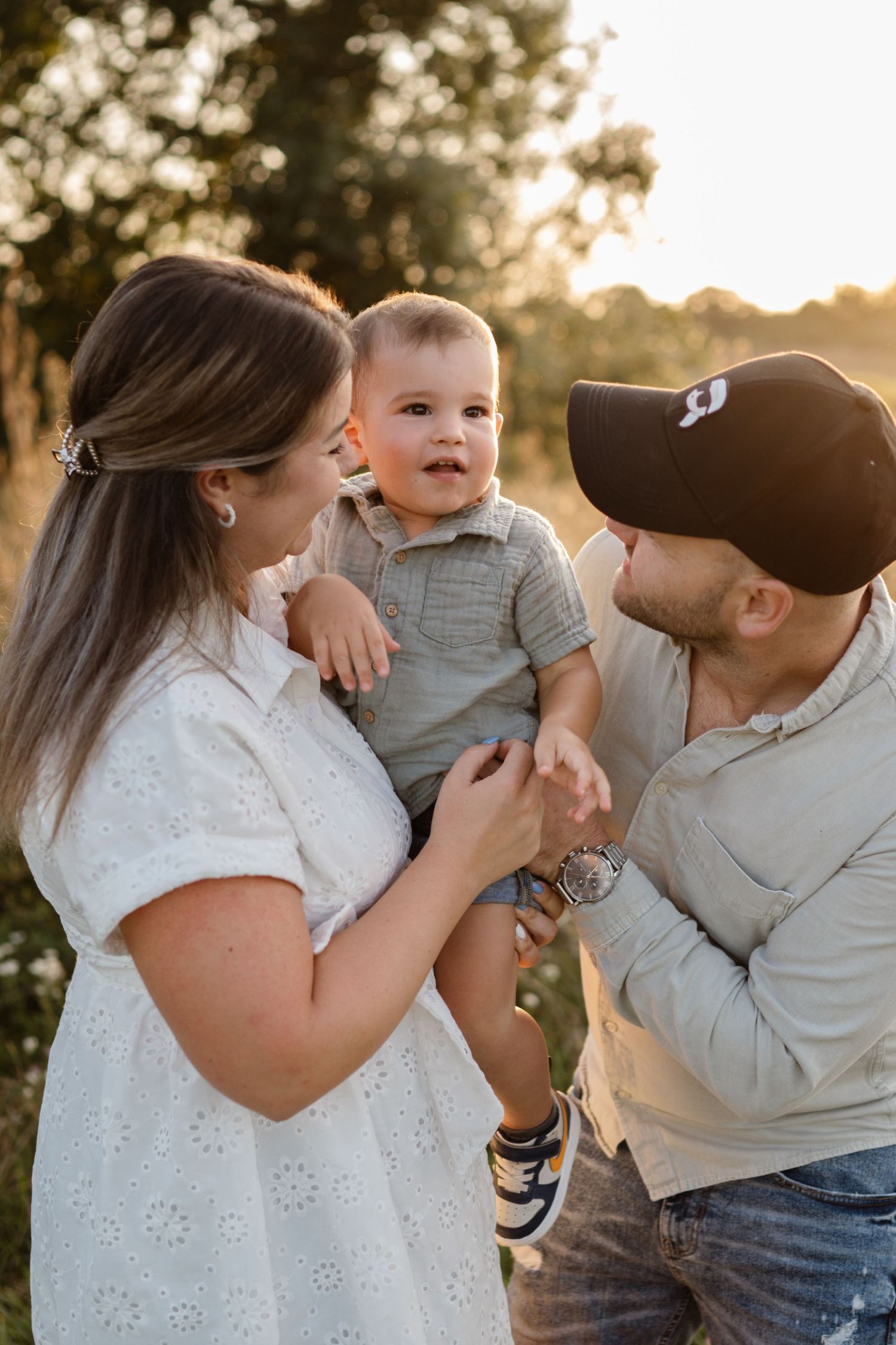 Family sharing joyful moment together during golden hour in park.