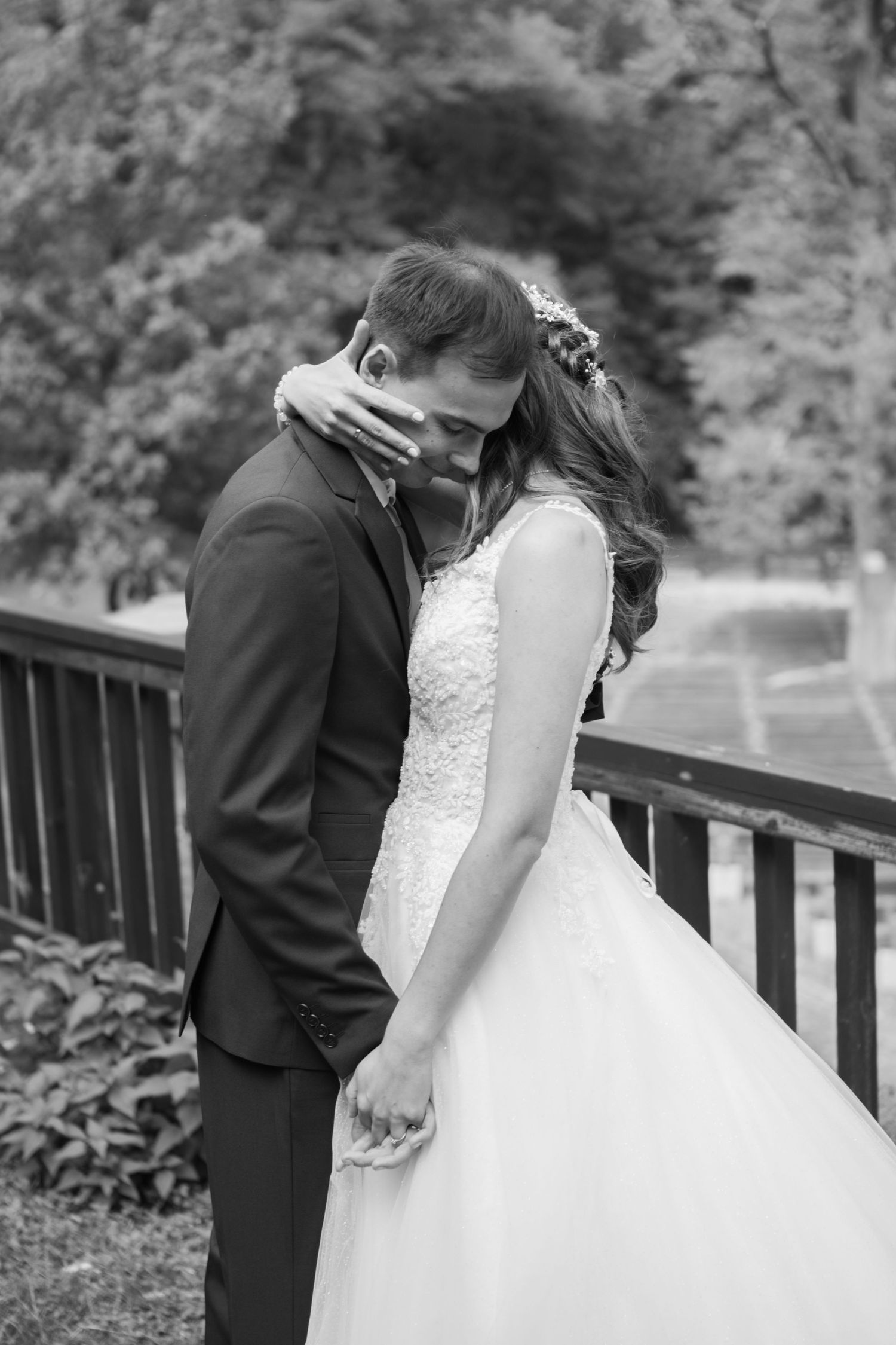 Black and white wedding portrait session on a wooden deck.