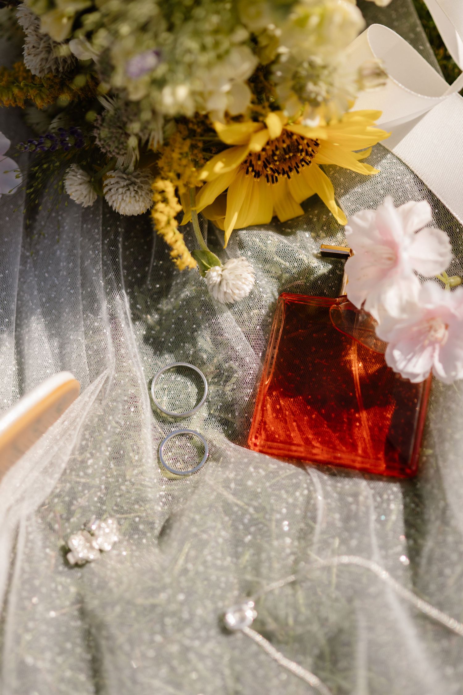 Artistic composition with sunflowers and pink flowers against a glittery background.