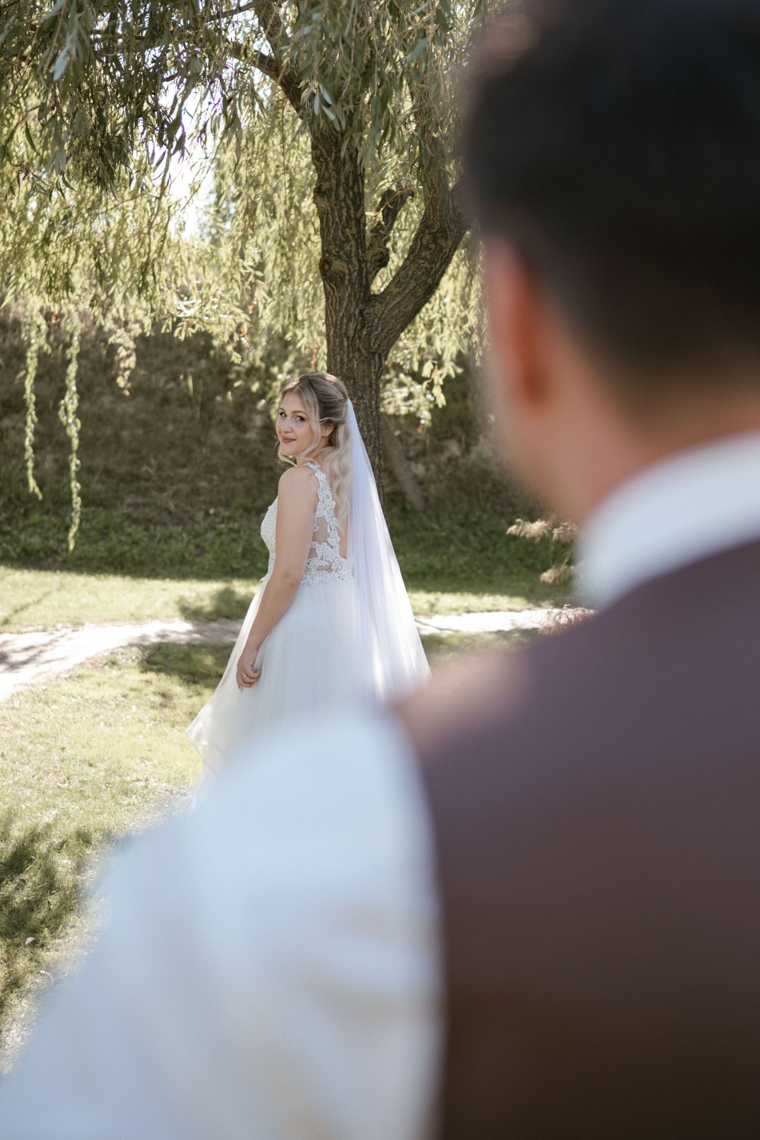 Artistic wedding photography shots focusing on the bride's dress and veil details.